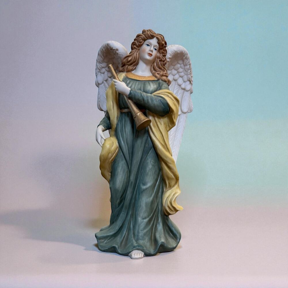 O'Well Grandeur Noel Collector's Edition porcelain angel statue holding a horn.